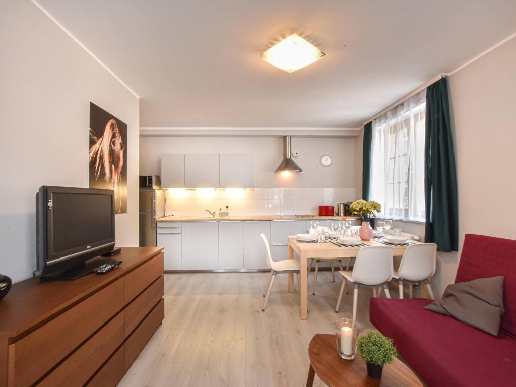 Televízia a/alebo spoločenská miestnosť v ubytovaní VacationClub – Osiedle Podgórze 1E Apartament 19