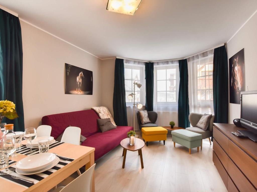 Televízia a/alebo spoločenská miestnosť v ubytovaní VacationClub – Osiedle Podgórze 1E Apartament 19