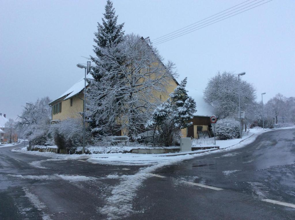 a house is covered in snow on a street at CASA-Li old Farmhouse in Tengen