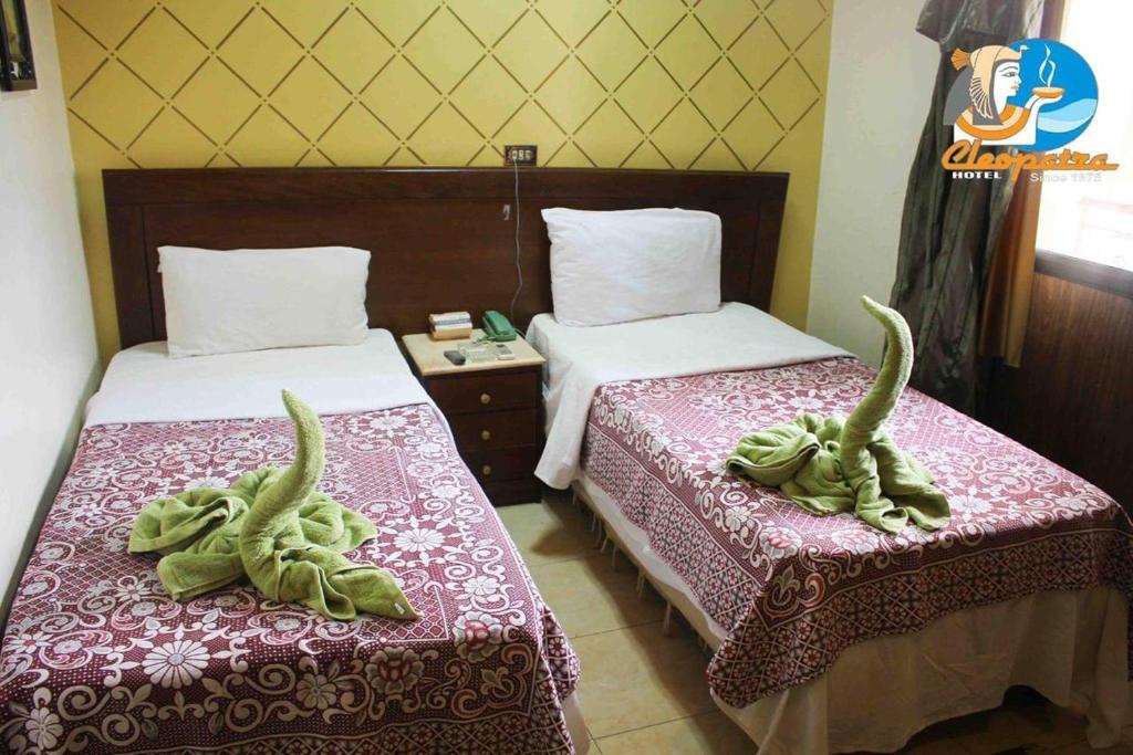 Cama o camas de una habitación en فندق جراند كليوباترا المحلة