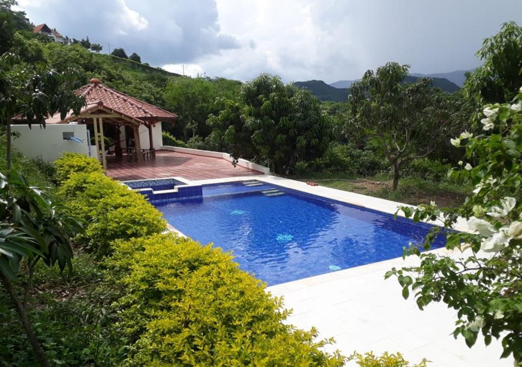 a swimming pool in front of a house at FINCA LUNADAR ANAPOIMA in Anapoima