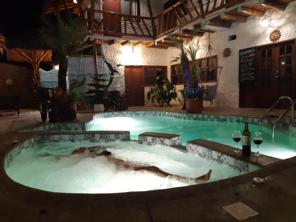 a large pool of water in a building with at The Weekend Hostal in Montañita