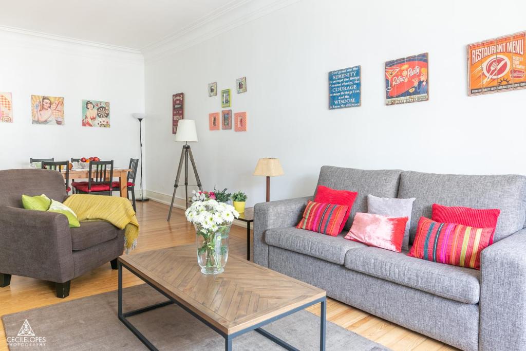a living room with two couches and a table at Casa da Avenida Lisboa in Lisbon