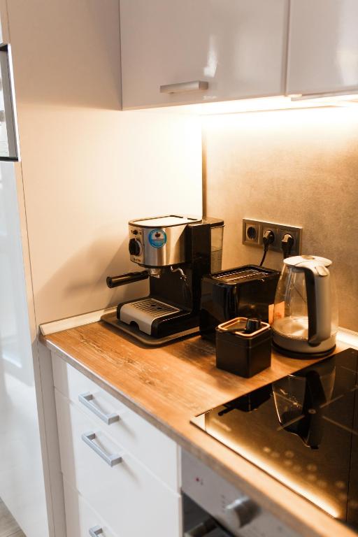 a kitchen counter with a coffee maker and a toaster at Style Стильні апартаменти в ЖК "Варшавський" біля парку in Ternopilʼ