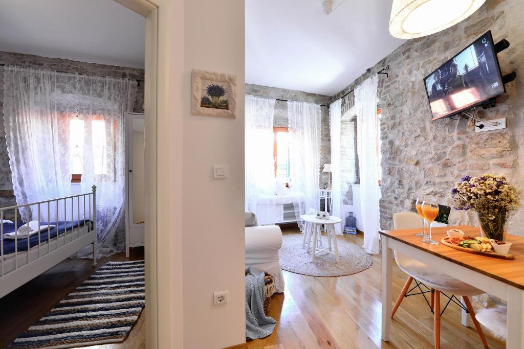 a living room with a stone wall at Apartments Toma in Split