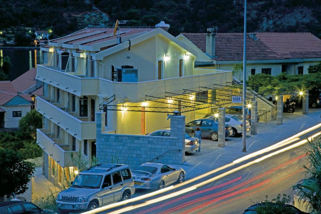 a house with cars parked in front of it at night at Accommodation Marija 2 in Kotor