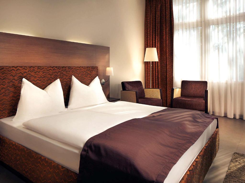 Postel nebo postele na pokoji v ubytování Hotel Mercure Graz City