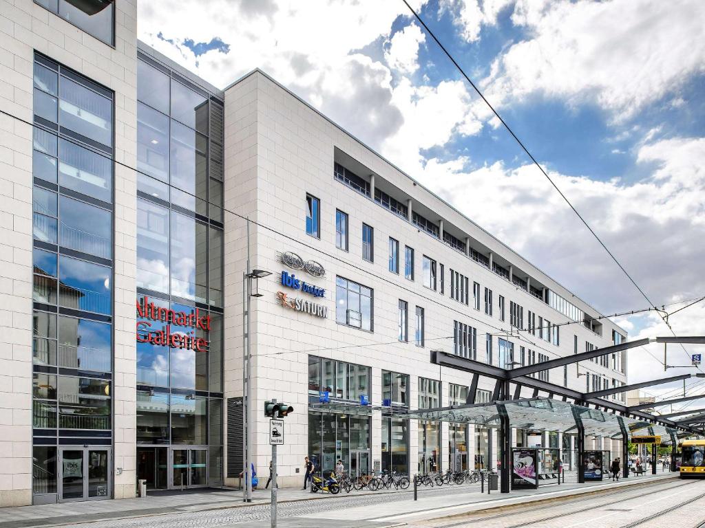 a large white building on a street with at ibis budget Dresden City in Dresden