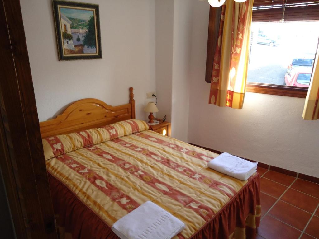 Cama o camas de una habitación en Apartamentos Rurales Las Chimeneas