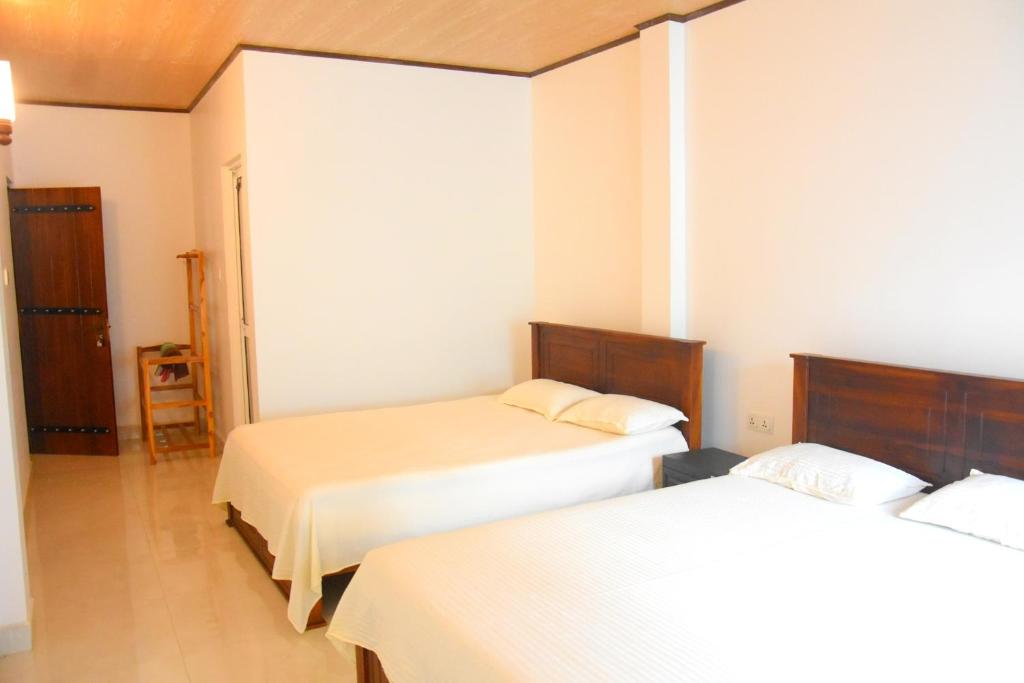 Postel nebo postele na pokoji v ubytování Wingate Hotel Wilgamuwa