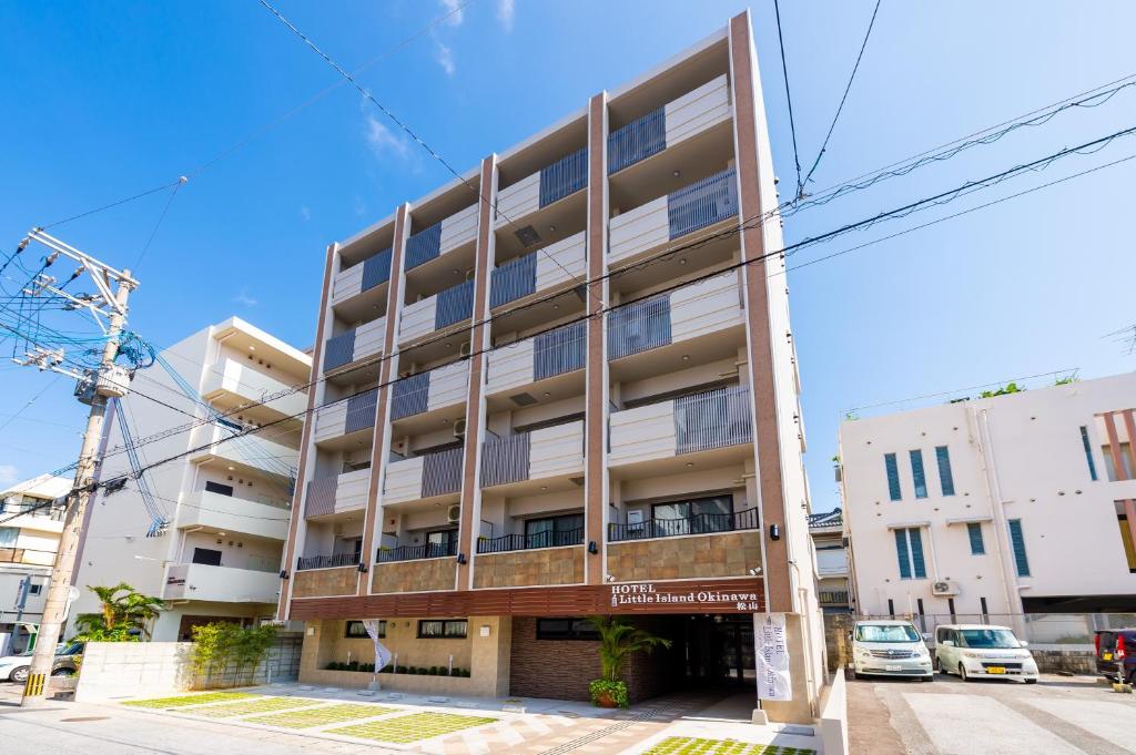 an apartment building on the corner of a street at Hotel Little Island Okinawa Matsuyama in Naha