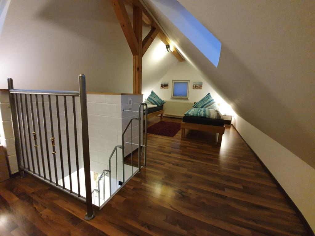 a hallway with a staircase and a living room at Ferienwohnung Häusla in Hirschaid