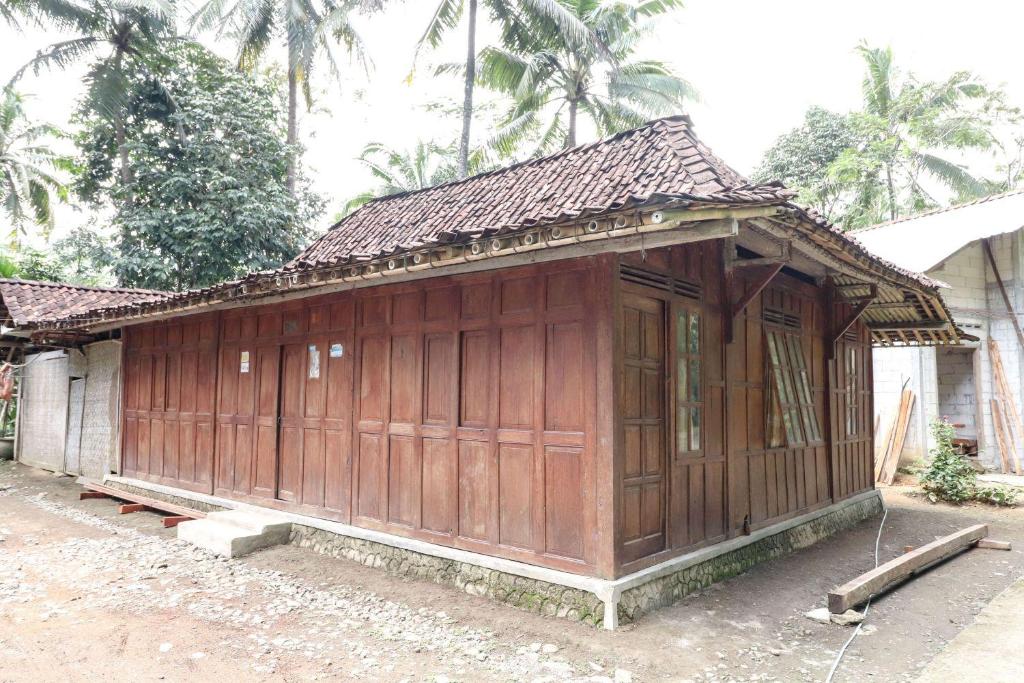 a small wooden building in front of a house at Homestay Mbah Parni in Sermo