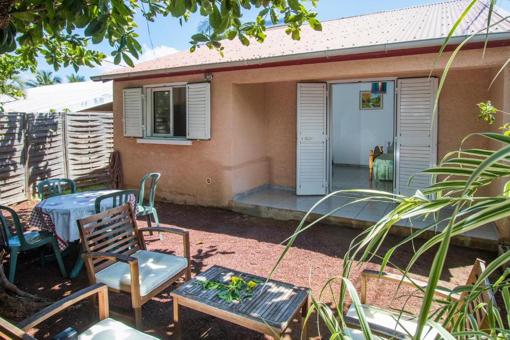 una casa con una mesa y sillas frente a ella en Capucine Location en La Saline les Bains