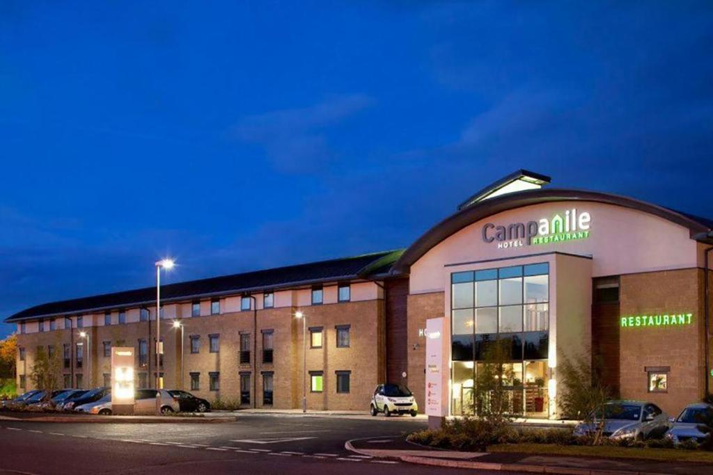 a large building with a clock on the front of it at Campanile Hotel Northampton in Northampton
