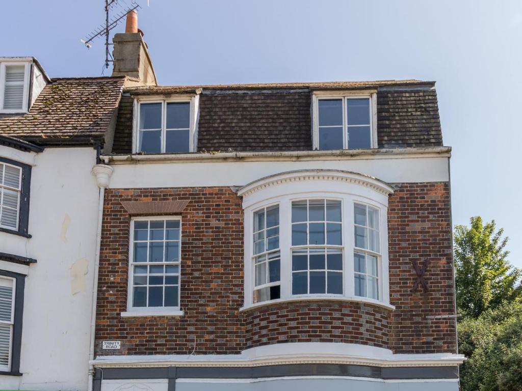 a brick house with a large window at Sailor's Watch in Weymouth