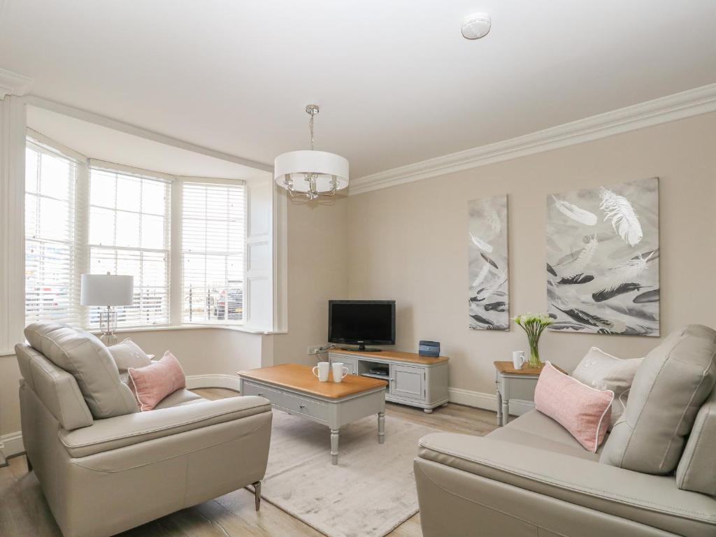 a living room with two couches and a tv at Harbour Watch 2 in Weymouth