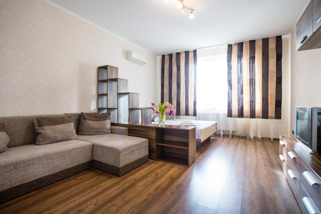 a living room with a couch and a television at Apartment near Obolon metro station in Kyiv