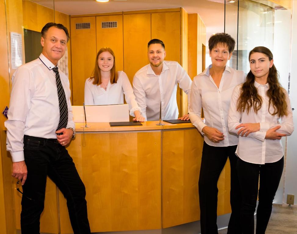 a group of people standing in front of a desk at City Hotel Heilbronn in Heilbronn