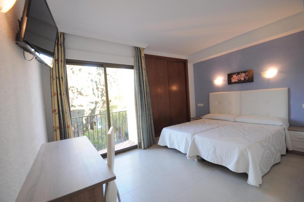 Postel nebo postele na pokoji v ubytování Hotel Goya
