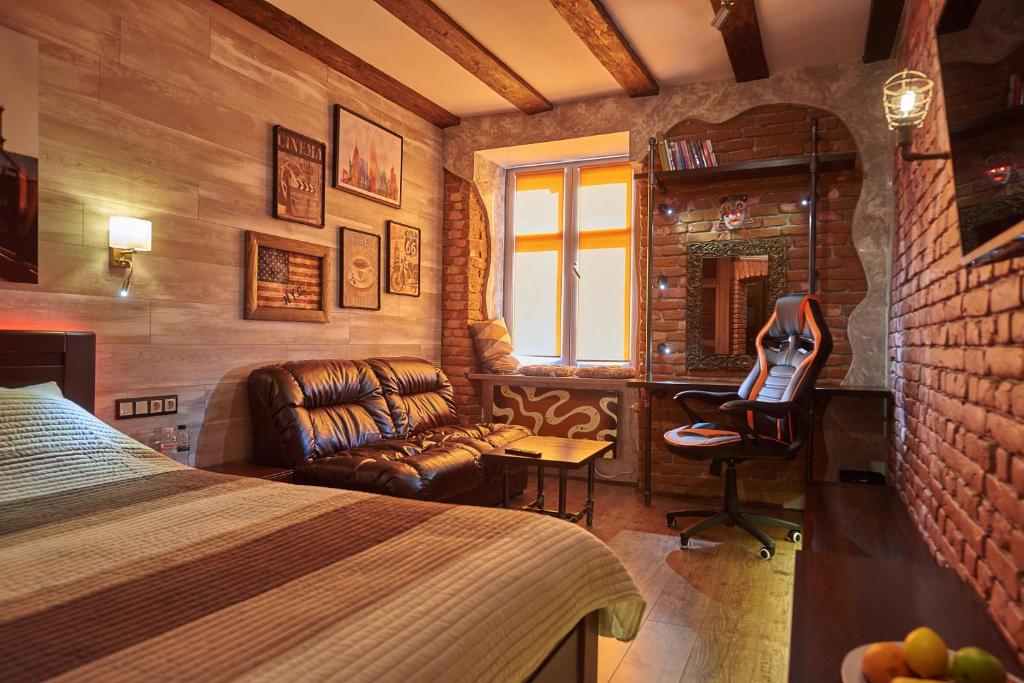 a bedroom with a bed and a desk and a chair at Quarter (25) in Lviv
