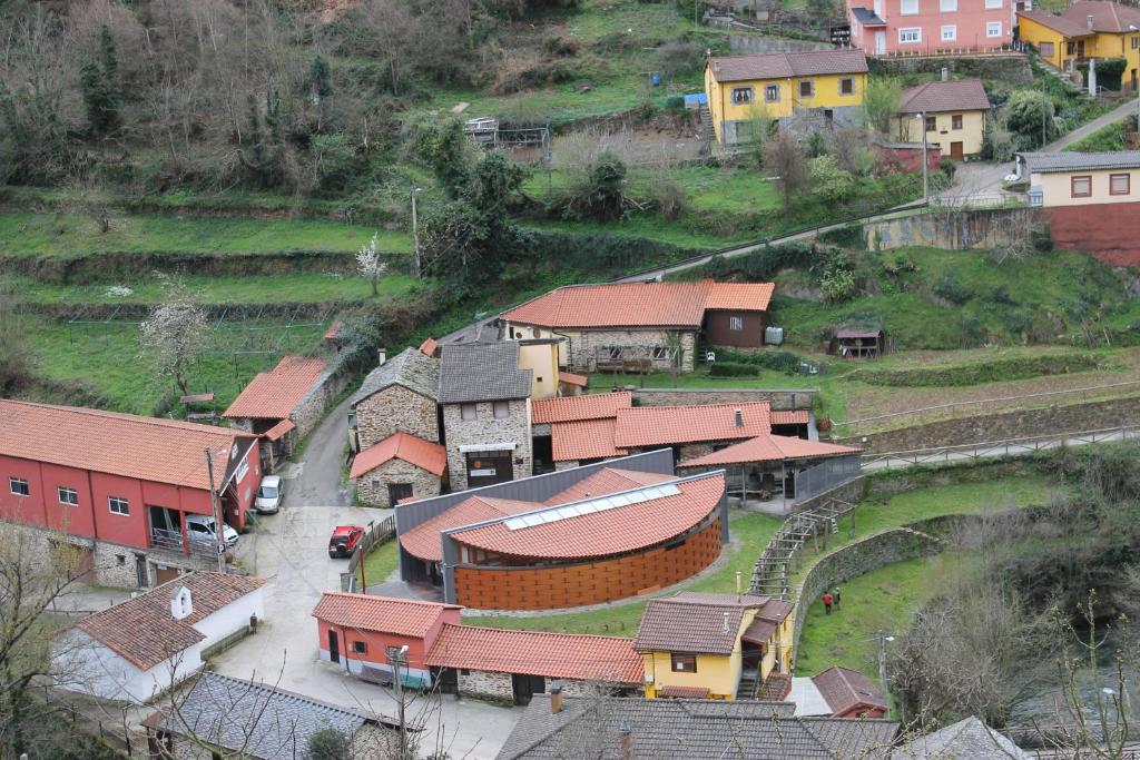 an aerial view of a village with houses and a road at La Puchera in Cangas del Narcea