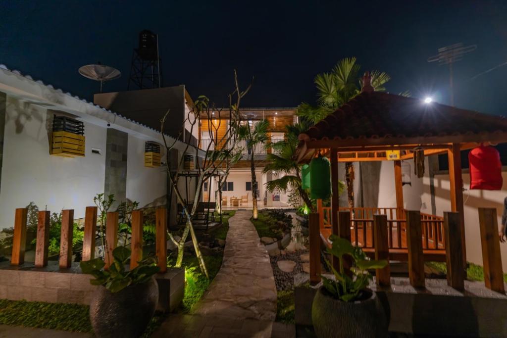 a house with a fence in front of it at night at Fredelia homestay in Bromo