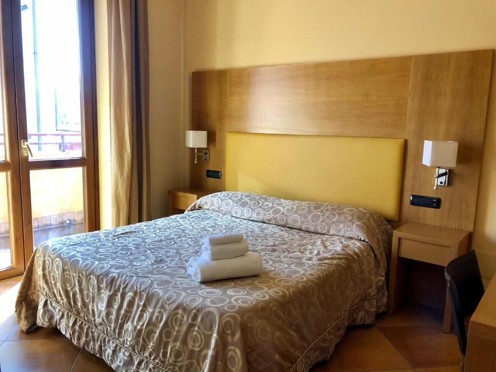 Postel nebo postele na pokoji v ubytování Mingone Hotel Ristorante