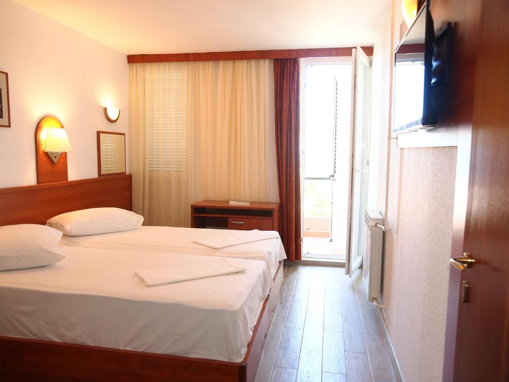 Postel nebo postele na pokoji v ubytování Hotel Aurora