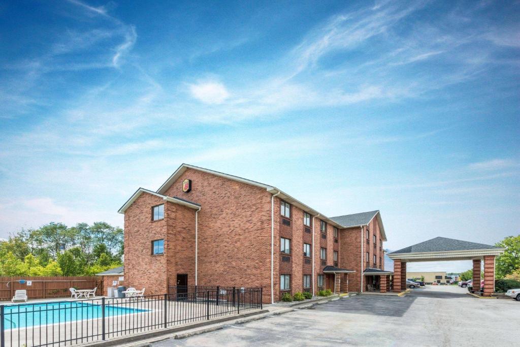 a brick building with a pool in front of it at Super 8 by Wyndham Georgetown in Georgetown