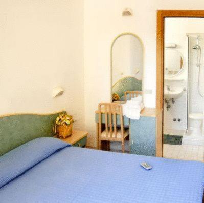 Postel nebo postele na pokoji v ubytování Hotel Vallechiara