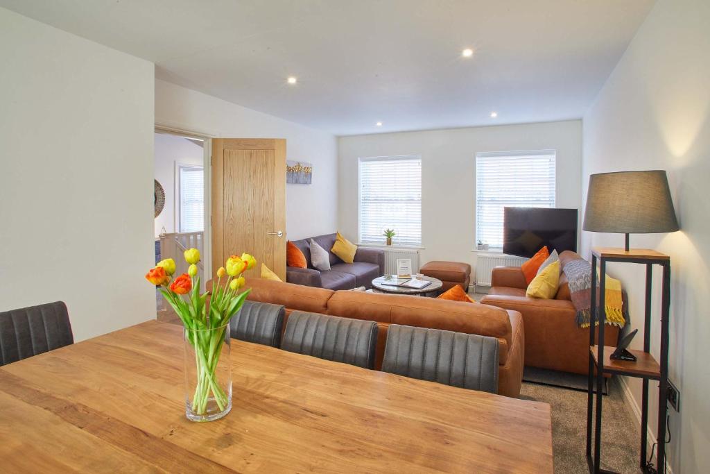 a living room with a vase of flowers on a table at Host & Stay - Lemonade Arch in Whitby