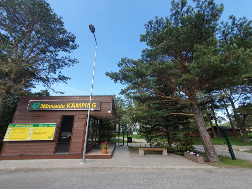 a park with a bench in front of a building at Camping Männisalu in Toila