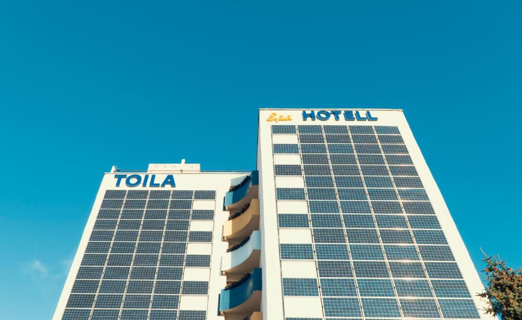 two high rise buildings with the tulsa hotel at Toila Spa Hotel in Toila