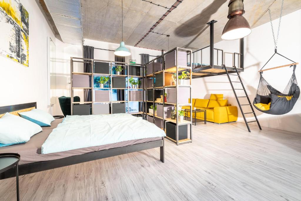 a bedroom with a bed and a book shelf at Industrial Apartment ZERO in Bratislava