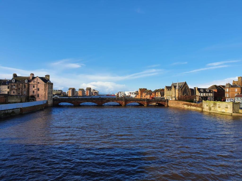 a bridge over a river in a city at Ayr Riverside Apartments in Ayr