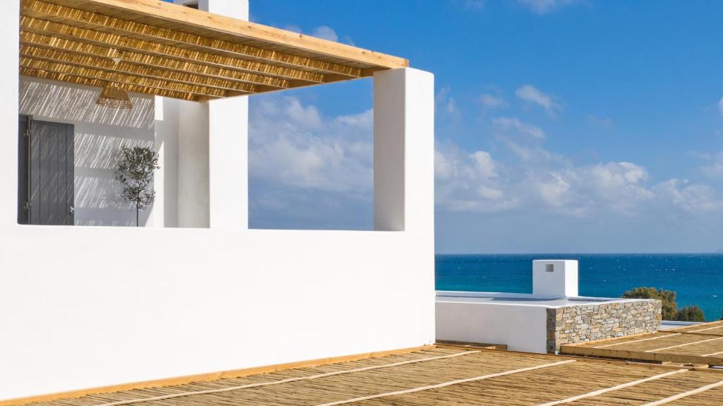 a white house with a view of the ocean at Vastblue of Paros in Ambelas