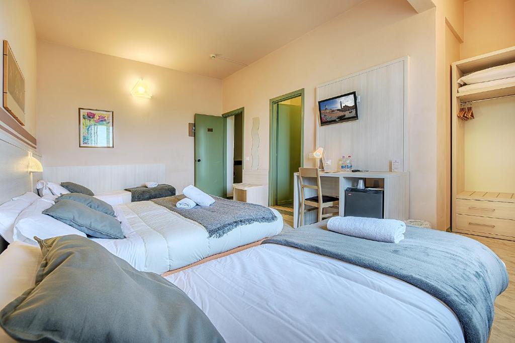 Postel nebo postele na pokoji v ubytování Hotel Castello