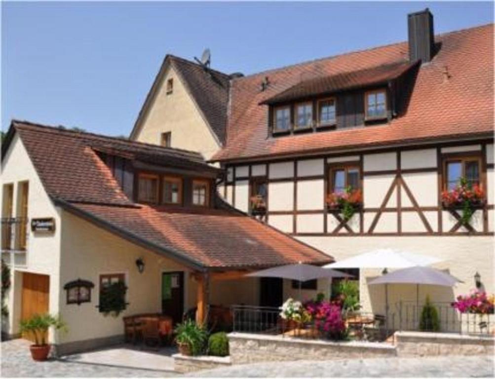a large white building with red roof at Gasthaus Tauberstube in Rothenburg ob der Tauber