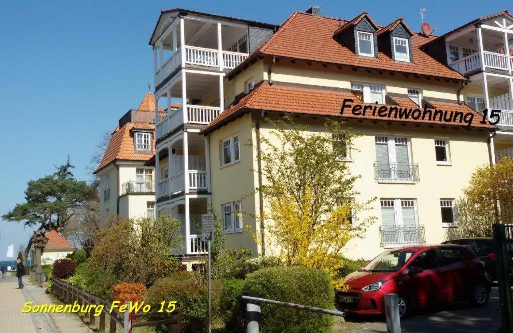 a large white building with a red roof at Appartmenthaus Sonnenburg in Kühlungsborn