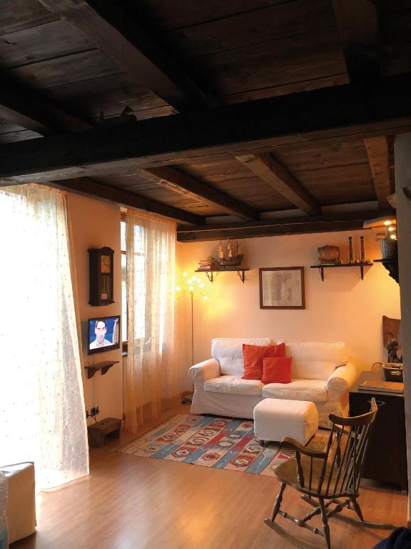 a living room with a couch and a table at Gabry’s Home in Pianello Del Lario