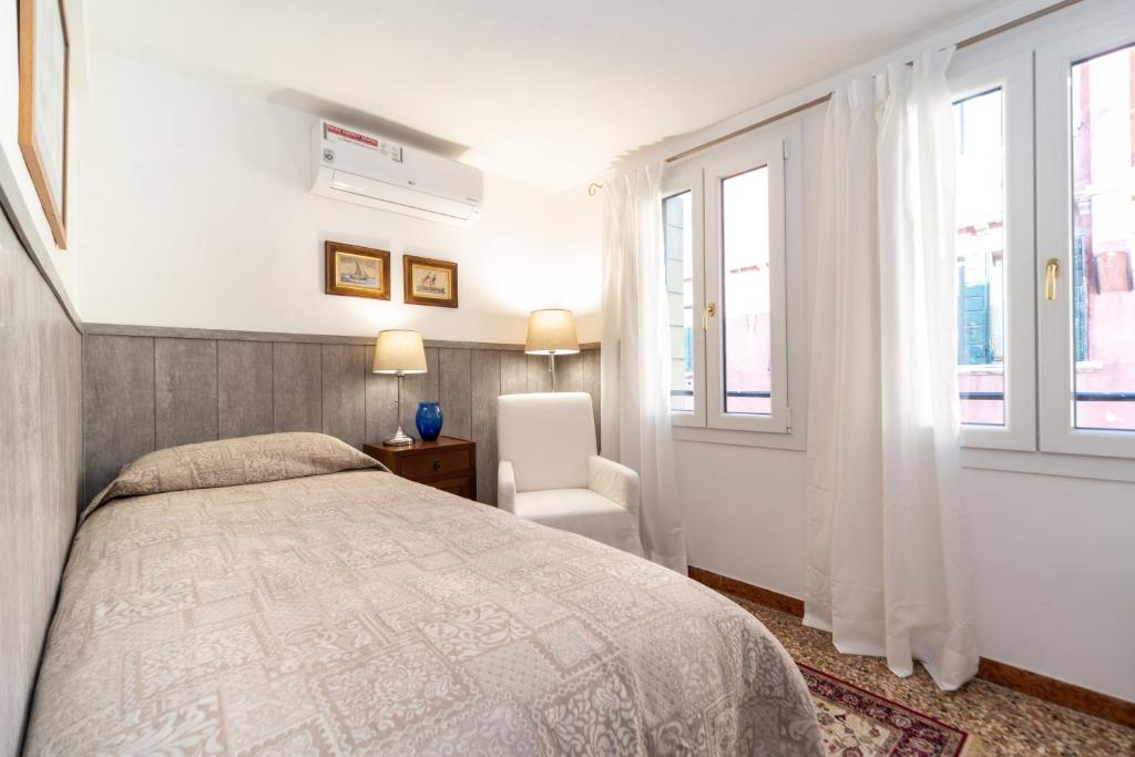 A bed or beds in a room at Ca' Terrazza di Marco Polo