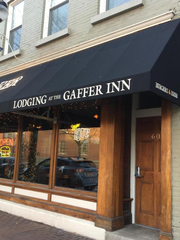 a restaurant with a black awning on a building at Lodging at the Gaffer Inn in Corning