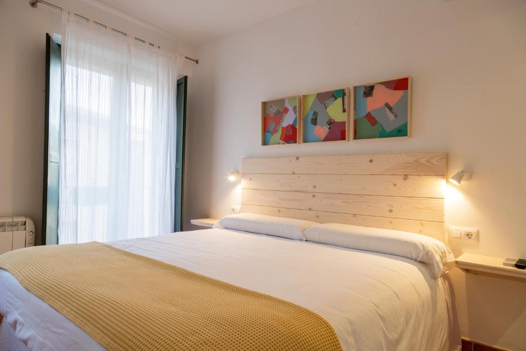 um quarto com uma cama grande e uma janela em Hotel 3 Arcs em Besalú