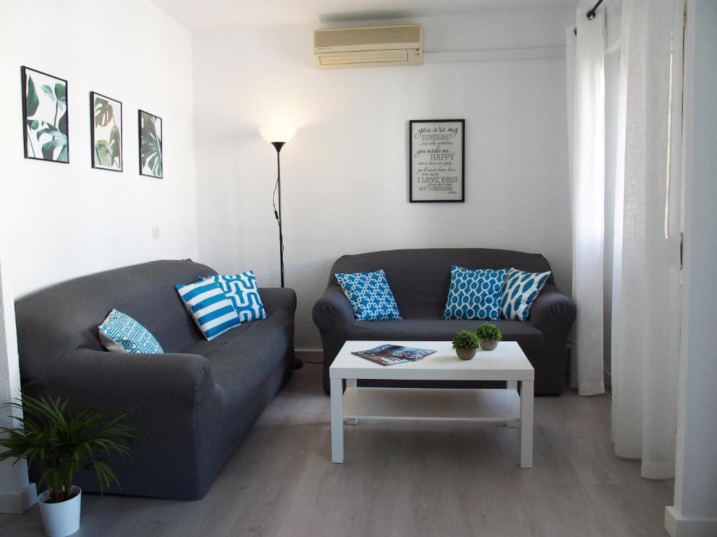 a living room with two couches and a coffee table at El piso de Ursula in Ayamonte