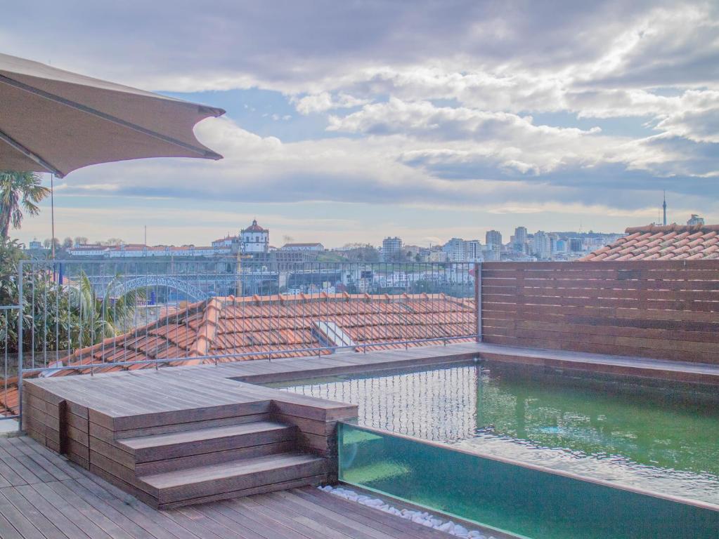a swimming pool on the roof of a building at PipaD'oro by YoursPorto in Porto