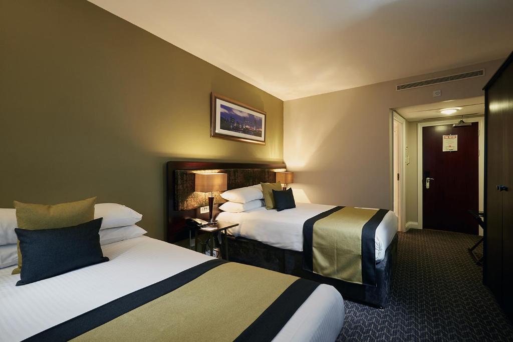a hotel room with two beds in a room at Stamford Bridge Hotel London in London