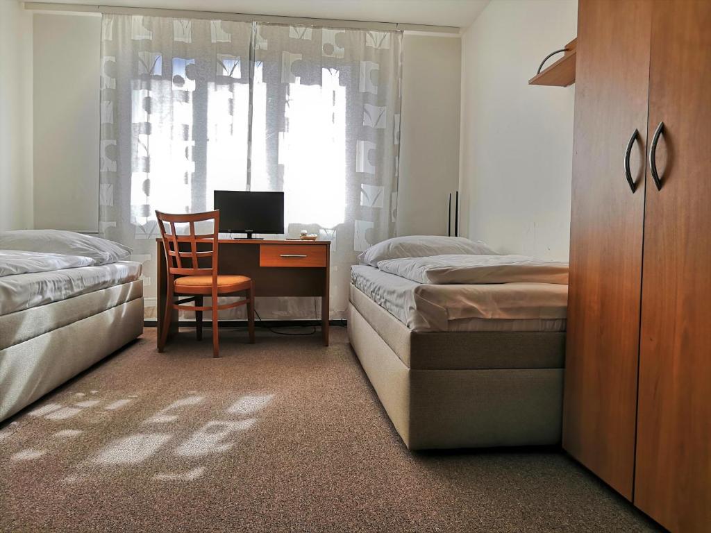 Postel nebo postele na pokoji v ubytování Hotel Marianeum