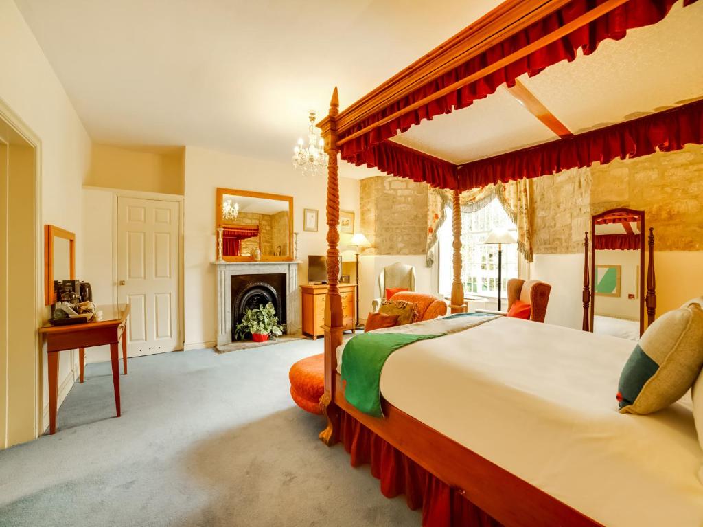 a bedroom with a large bed and a large window at OYO Bailbrook Lodge in Bath