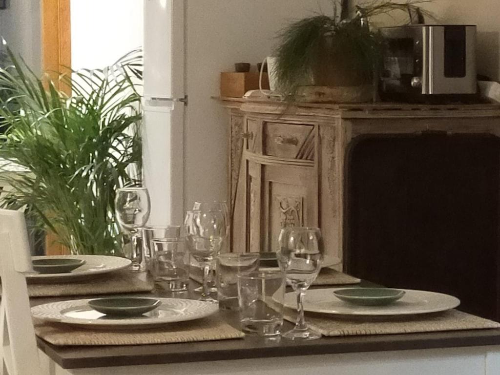 a table with plates and wine glasses on it at Casa Francesca Altea piscina y aparcamiento privado in Altea
